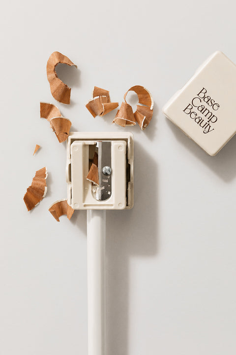 Pencil sharpener with pencil shavings on a light background